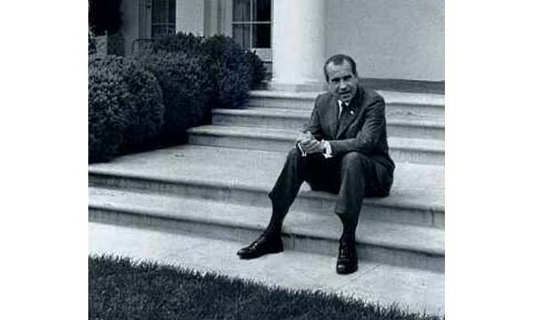 Richard Nixon sitting on a step at the White House
